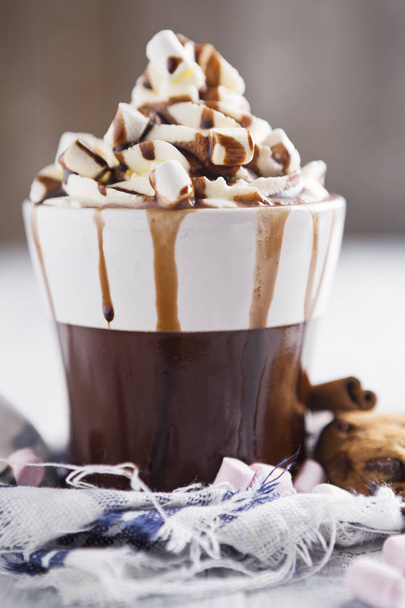 Messy hot chocolate, cream and marshmallows and a choc-chip cook - Φωτογραφία, εικόνα
