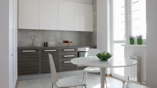 4K. Interior of modern kitchen in scandinavian style. Motion panoramic view. - Záběry, video