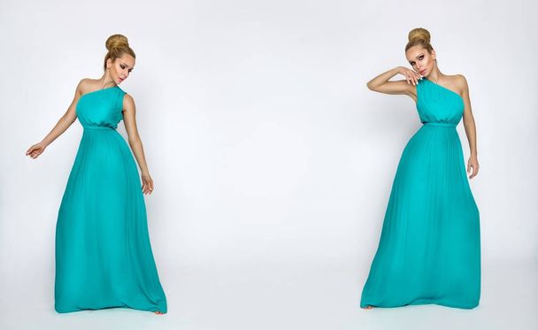 Elegante vrouwelijke model in een turquoise lange zijden jurk staande op een witte achtergrond en sensueel vormt - Foto, afbeelding
