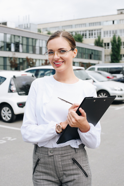 businesswoman holding clipboard - Photo, Image