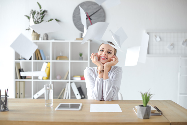Cheerful businesswoman at desk in office - Photo, Image