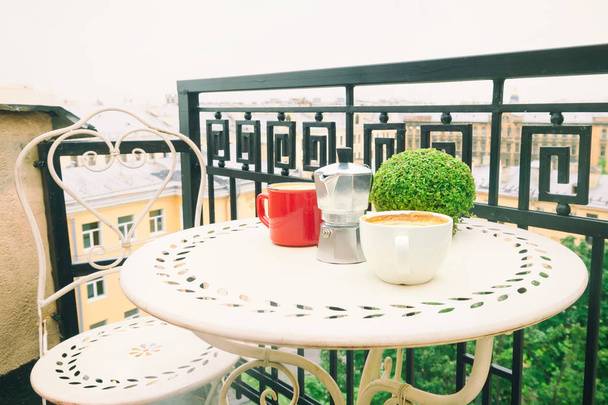 Coffee on table on the balcony - Фото, изображение