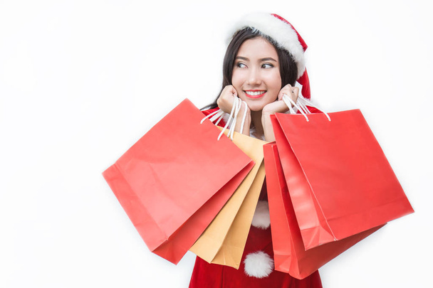 Asian woman in santa claus costume holding shopping bags isolated on white background  - Foto, Imagen