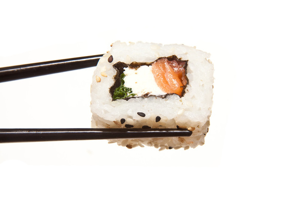 Holding sushi with chopsticks - 写真・画像