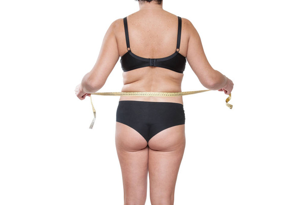 Teyp-ölçü birimi kullanılarak siyah iç çamaşırı tombul kadın - Fotoğraf, Görsel