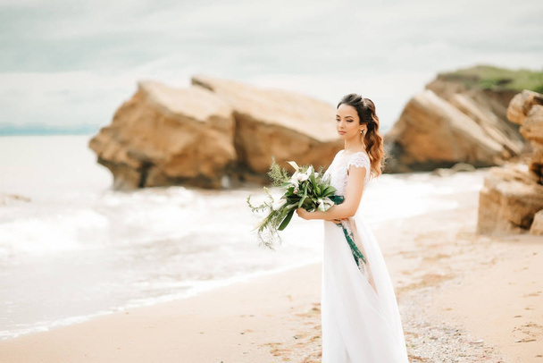 young bride on a sandy beach - Fotó, kép