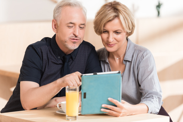 Couple looking something at tablet - Photo, Image