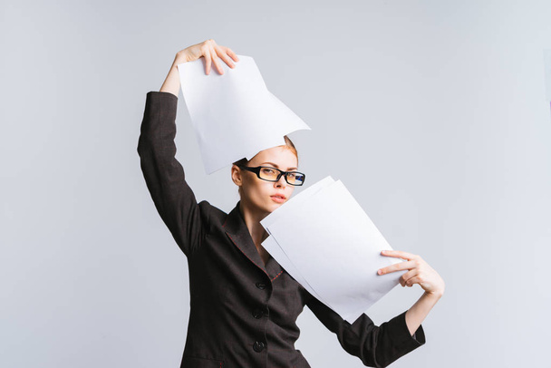 the girl in a business black suit is beautifully holding papers - 写真・画像
