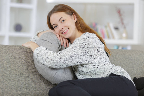 relaxed young girl hugging a cushion - Zdjęcie, obraz