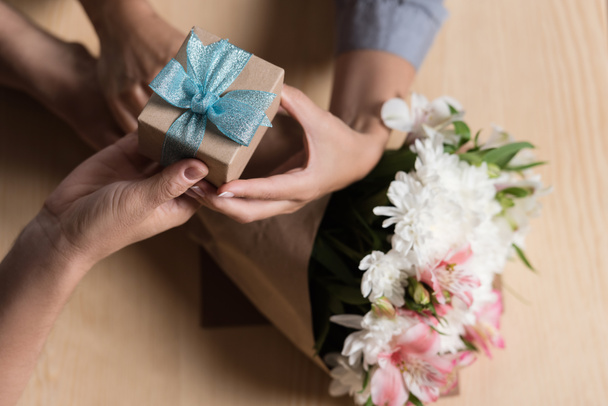 Man presenting gift to woman - Photo, image