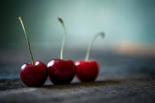 Cherry on wooden board. Tree cherries, selective focus - Foto, afbeelding