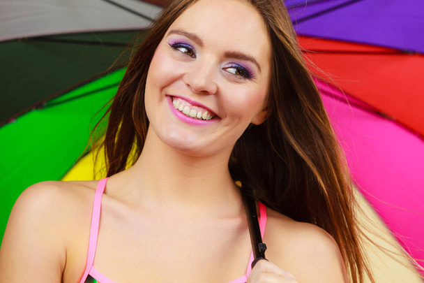 Woman standing under colorful rainbow umbrella - Photo, Image