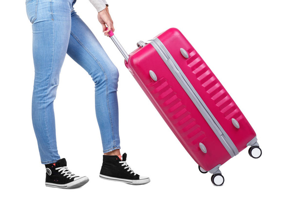 Girl traveler with a pink suitcase. Isolated on white background. - Φωτογραφία, εικόνα