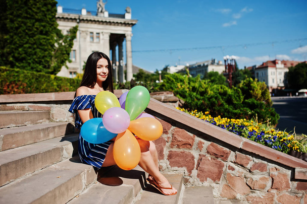 Gorgeous brunette girl at street of city with balloons at hands. - Fotografie, Obrázek