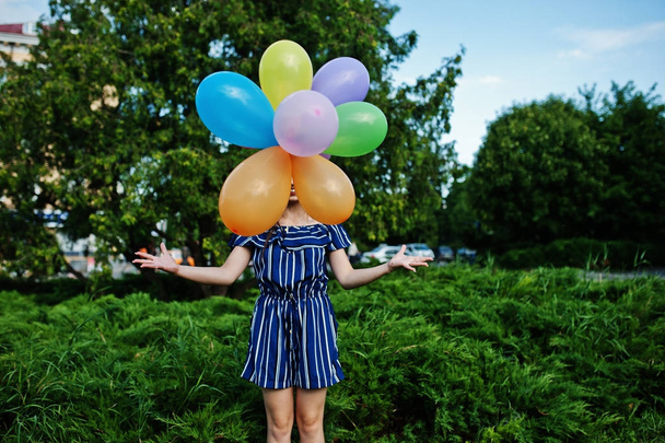 Gorgeous brunette girl at street of city with balloons at hands. - Fotografie, Obrázek