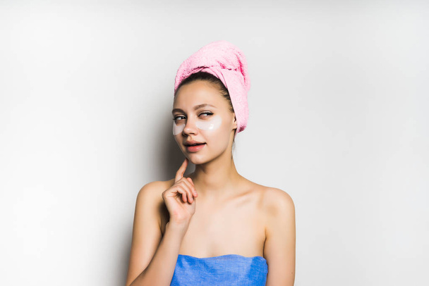 the girl came out of the shower with a towel on her head, thought about something and looked away - Fotografie, Obrázek