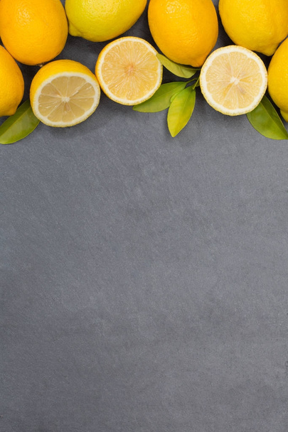 Lemon lemons fruits portrait format copyspace slate top view - Valokuva, kuva