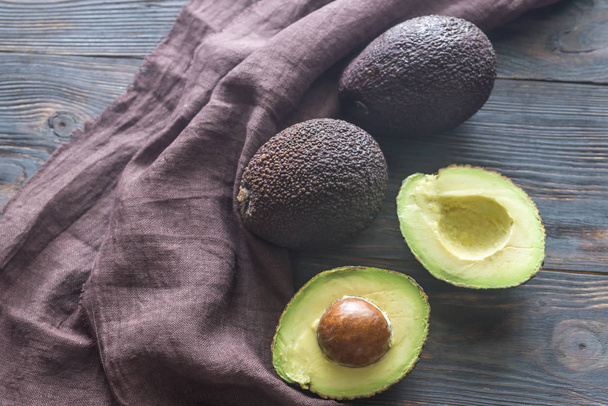 Hass avocados on the wooden background - Photo, Image