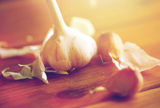close up of garlic on wooden table - Фото, изображение