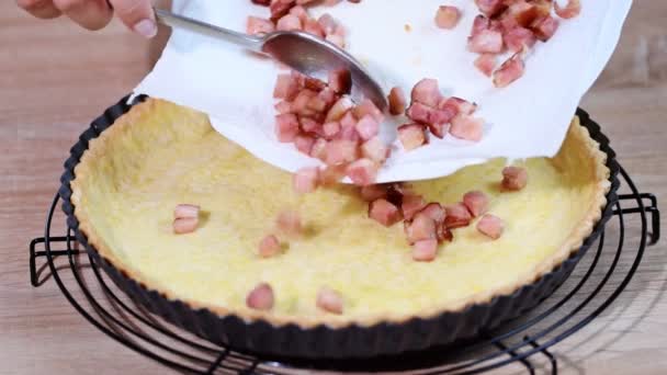 Cooking Quiche Lorraine. Put the toppings bacon in the tart. - Footage, Video