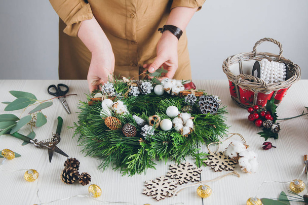 Florist decorator making Christmas wreath  - 写真・画像