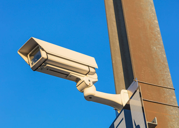 Surveillance camera against blue sky - Photo, Image