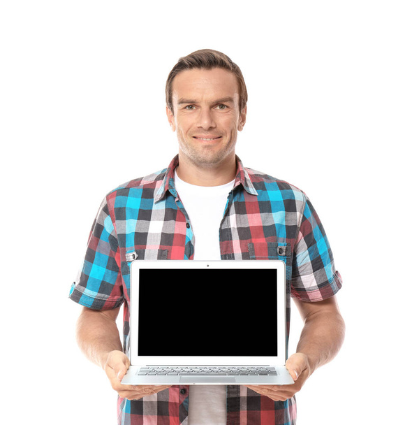 Young man holding laptop on white background - Zdjęcie, obraz