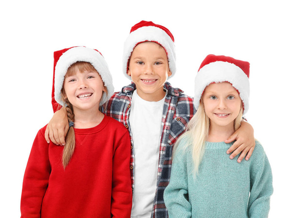 Cute children in Santa hats on white background - Foto, Bild
