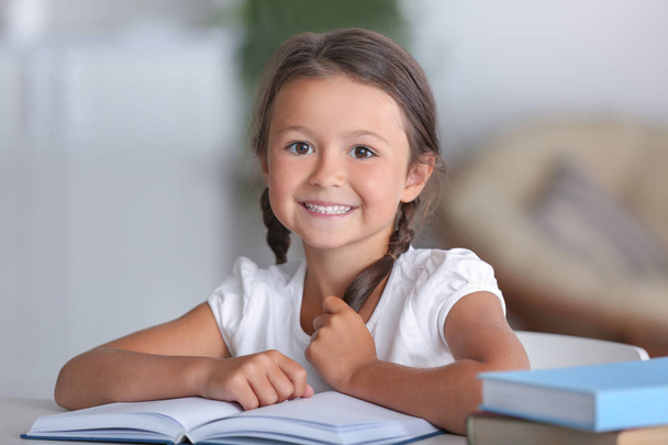 Cute little girl reading book  - Фото, изображение