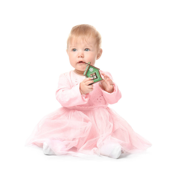 Adorable baby with small house toy on white background - Photo, Image