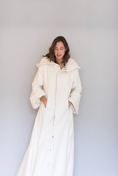 woman in a white coat with hood  - 写真・画像