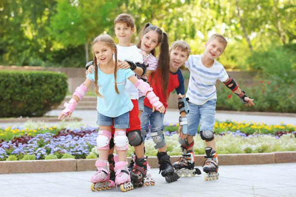 Active children rollerskating in park - Photo, Image