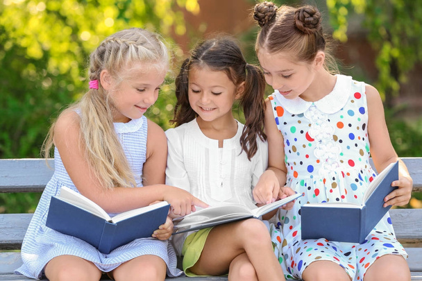 Cute little children reading books in park - 写真・画像