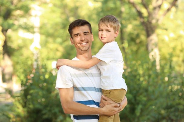 Father with son in park on sunny day - Photo, image