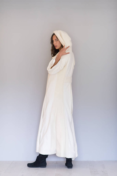 woman in a white coat with hood isolated  - Valokuva, kuva