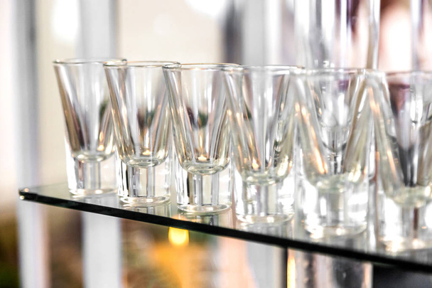 Catering services. Celebration. glasses with alcohol placed on the glass - Photo, Image