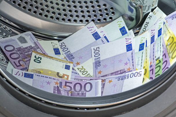 primo piano della pila di banconote in euro (EUR) con banconote da 500, 200, 100 e 50 euro collocate in lavatrice. Concetto di riciclaggio di denaro
  - Foto, immagini