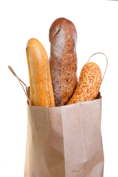 Bread in paper bag on white background.  - Photo, Image