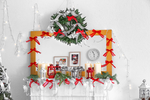 Mantelpiece decorated with candles and Christmas lights - Fotografie, Obrázek