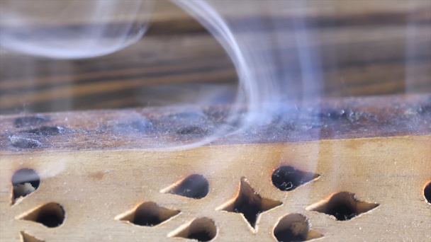 Mooie aroma rook in de buurt van het beeldje. uddha figuur op houten thee Board Chaban met een Aroma roken. Macro dicht stokjes omhoog van brandende wierook met rook Over bruine achtergrond. - Foto, afbeelding