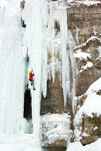 Ice climbing the waterfall. - Zdjęcie, obraz