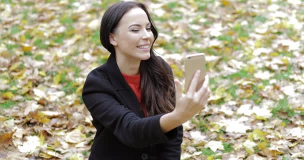 Woman taking selfie on grass - Video