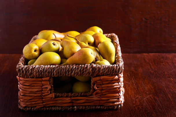 Many pears in a basket  - Фото, изображение