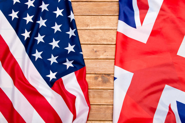 UK flag and USA Flag on wooden background. - Fotografie, Obrázek