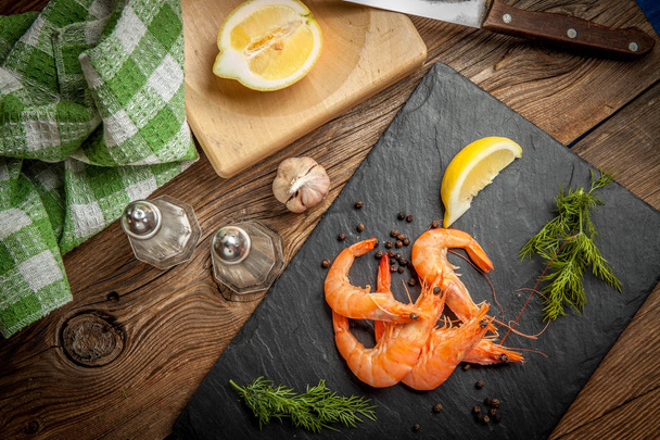 Shrimps for dinner on stone plate. - Foto, afbeelding