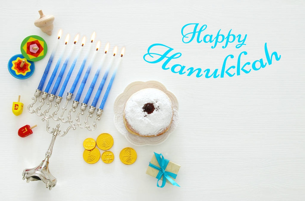 Top view image of jewish holiday Hanukkah background with traditional spinnig top, menorah (traditional candelabra) - Фото, изображение