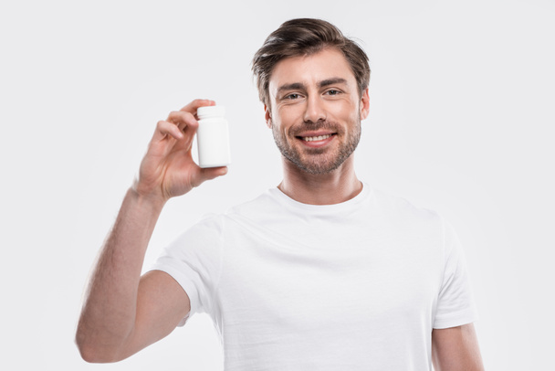 homme présentant des vitamines en bouteille
 - Photo, image
