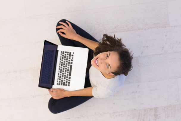 woman using laptop computer on the floor top view - 写真・画像