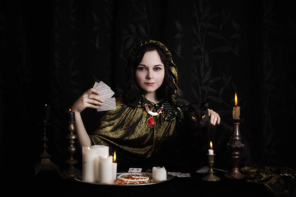 Young woman with divination cards in room - Фото, зображення