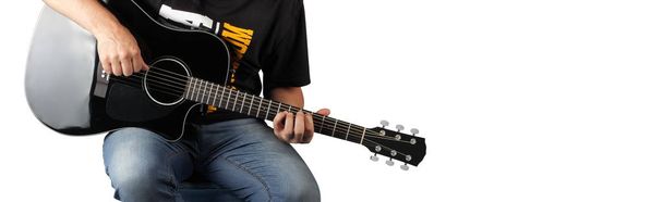 Μουσική - θραύσμα ανθρώπου παίζουν ένα μαύρο ακουστική κιθάρα. - Φωτογραφία, εικόνα